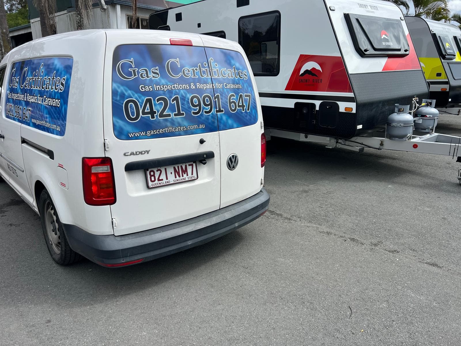 Gas Certificates mobile service van beside a caravan with LPG gas cylinders, ready for a gas safety inspection